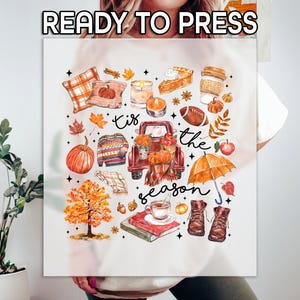 May include: A white sublimation blank t-shirt with a fall-themed design featuring a red truck, pumpkins, leaves, and the text "Tis the season".