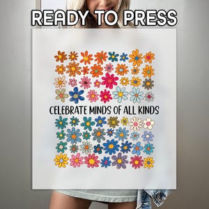 May include: A white t-shirt with a colorful flower design and the text "Celebrate Minds of All Kinds".