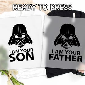 May include: Two iron-on transfers featuring a black and white illustration of Darth Vader. The text on the left transfer reads "I am your son". The text on the right transfer reads "I am your father".