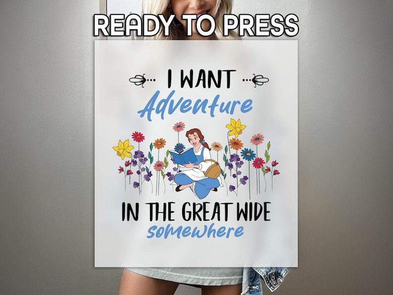 May include: White canvas with the text "READY TO PRESS" at the top. The image features a cartoon of a woman reading a book, surrounded by colorful flowers. The text "I WANT Adventure IN THE GREAT WIDE somewhere" is also displayed.