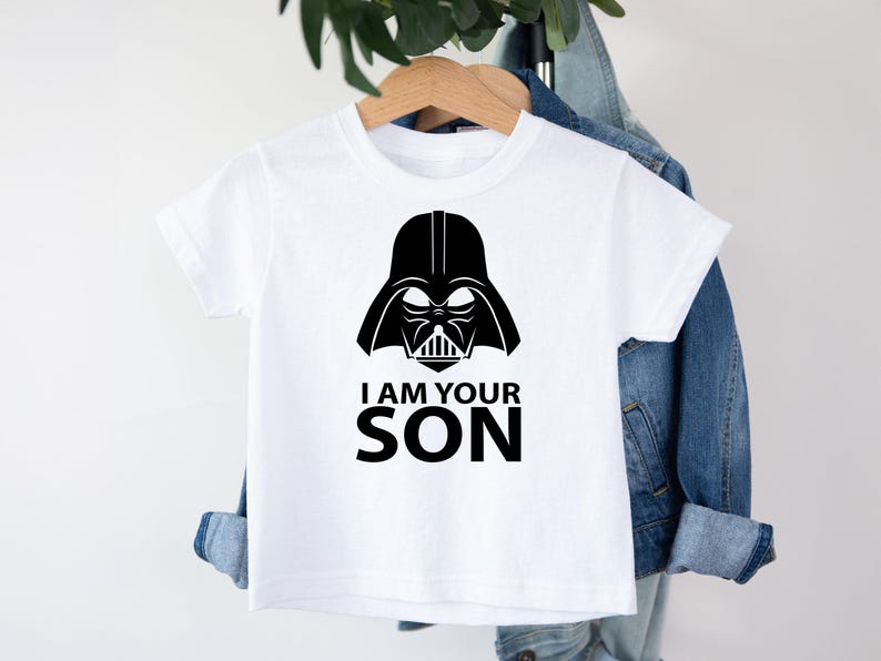 May include: White t-shirt with a black Darth Vader graphic and the text "I am your son".