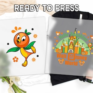 May include: Two ready-to-press designs featuring the Orange Bird character. One design is on a white background and the other is on a gray background. The white design has the Orange Bird character with orange and green colors. The gray design says "Walt Disney World".