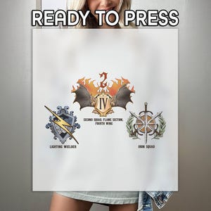 May include: A white t-shirt with three iron-on patches. The patches are in a triangular formation. The top patch is a red, orange, and yellow flame with a bat and the text "IV Second Squad, Flame Section Fourth Wing". The left patch is a blue and gray shield with a lightning bolt and the text "Lighting Wielder". The right patch is a blue and gray shield with a sword and the text "Iron Squad".