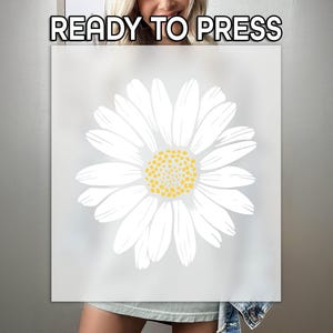 May include: A white daisy flower design with a yellow center is centered on a light gray background. The words "READY TO PRESS" are at the top. This design is suitable for heat transfer vinyl projects.