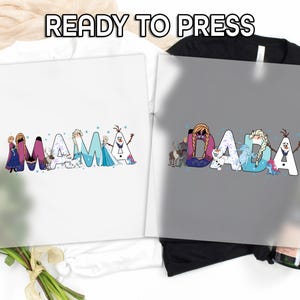 May include: White t-shirt with the word "MAMA" in colorful letters, each decorated with characters from a popular animated movie. A black t-shirt displays the word "DADA" in a similar style. The text "READY TO PRESS" is at the top.