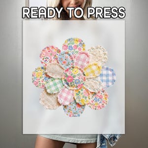 May include: A fabric flower applique featuring multiple petals made from various patterned textiles, including floral prints, gingham checks, and solid textures with frayed edges. The text READY TO PRESS is printed in white at the top of the image.