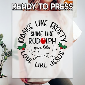 May include: White t-shirt with a black and red circle design that says "Dance like Frosty, Shine like Rudolph, Give like Santa, Love like Jesus".