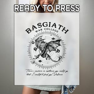 May include: A white t-shirt with a black and white graphic design of a dragon with the text "Basgiath War College" above it. The text below the dragon reads "There's nowhere in existence you could go that I wouldn't find you. Violence."