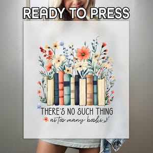 May include: A white t-shirt with a watercolor illustration of a stack of books surrounded by flowers. The text "There's no such thing as too many books" is printed below the illustration.