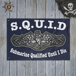 May include: Navy blue flag with white text reading "S.Q.U.I.D" above a submarine emblem and the words "Submarine Qualified Until I Die." A pirate flag and ship's wheel are in the background.