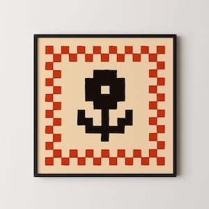 May include: A square framed wall art piece featuring a black pixelated flower graphic centered on a cream background. The design is enclosed by a red and cream checkered border pattern. The frame is thin and black, surrounding the square print.