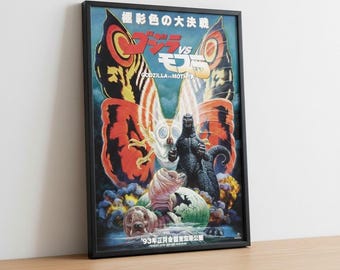 Op de afbeelding: Ingelijste filmposter voor "Godzilla vs. Mothra". Het kunstwerk heeft een levendig kleurenpalet met Godzilla en Mothra tegenover elkaar. Japanse tekst is zichtbaar aan de boven- en onderkant van de poster.
