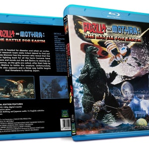 May include: Blu-ray disc of "Godzilla and Mothra: The Battle for Earth." The cover features Godzilla, Mothra, and a cityscape. The disc case is blue with text in English and Japanese. The back of the case has a plot summary.