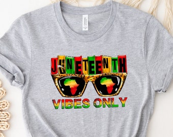 May include: Gray t-shirt with a graphic of sunglasses with the words "Juneteenth Vibes Only" in colorful letters.