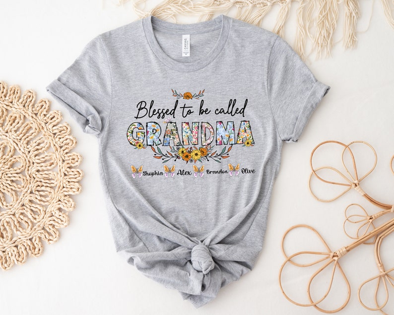 May include: Gray t-shirt with the text "Blessed to be called GRANDMA" in floral letters. The names Sophia, Alex, Braden, and Olive are written below the text.