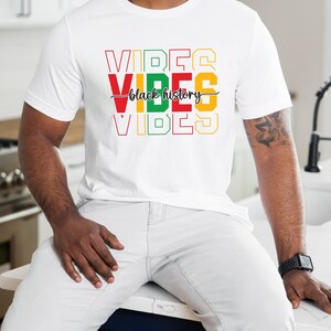 May include: A white t-shirt with the words "VIBES" in red, yellow, and green, with the words "black history" in black script between the words "VIBES".