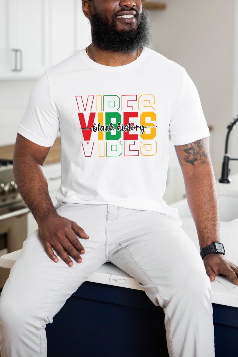 May include: A white t-shirt with the words "VIBES" in red, yellow, and green, with the words "black history" in black script between the words "VIBES".