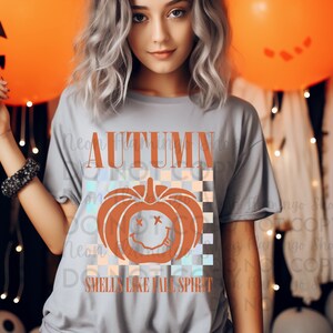 May include: Gray t-shirt with a graphic of a pumpkin with a smiley face and the text "AUTUMN SMELLS LIKE FALL SPIRIT".