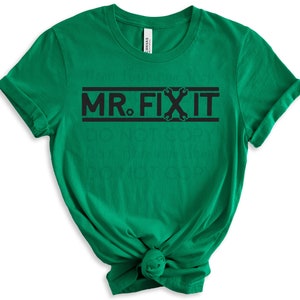 May include: Green t-shirt with black text that reads "MR. FIX IT" with a wrench graphic.