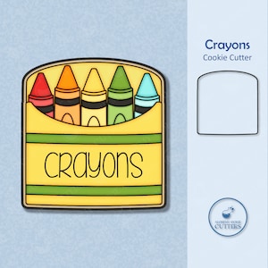 May include: A cookie cutter shaped like a box of crayons. The box is yellow with a green stripe and the word "crayons" written on it. There are five crayons inside the box, each a different color: red, orange, yellow, green, and blue.