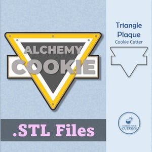 May include: A cookie cutter design with a triangle plaque shape. The design features the text "ALCHEMY COOKIE" in gray letters, set against a black and white triangle with a yellow border. The text ".STL Files" is in pink letters.