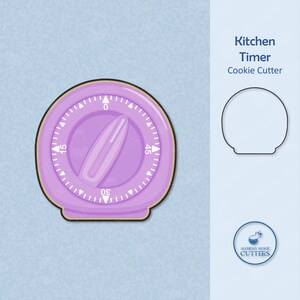 May include: A purple kitchen timer cookie cutter. The cutter is shaped like a round timer with a knob and numbers from 0 to 60. The cutter is on a light blue background.