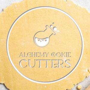 Alchemy Cookie Cutters Logo cut into rolled out dough.