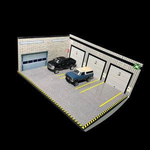 May include: A model garage diorama with three garage doors, two parking spaces, and two toy trucks. The garage doors are labeled 1, 2, and 3. The parking spaces have yellow lines. The diorama is made of cardboard and has a gray concrete floor.