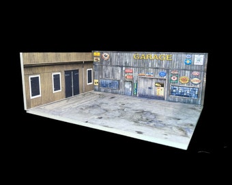 May include: A model of a garage with a wooden exterior and a sign that reads "GARAGE". The garage has a variety of signs and decals on the exterior, including a sign that reads "Auto Repair".