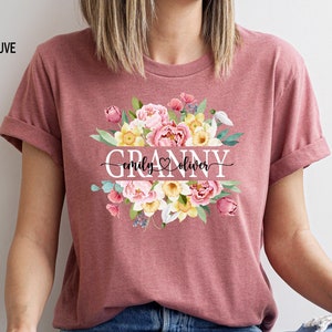 May include: Heather mauve t-shirt with a floral design and the text "Granny emily♡oliver" printed on the front.