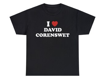 May include: Black t-shirt with the text "I ❤️ David Corenswet" in white lettering. The heart symbol is red. The shirt is a classic crew neck style.