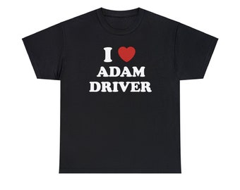 May include: Black t-shirt with the text "I ❤️ ADAM DRIVER" in white and red. The shirt features a white "I" followed by a red heart symbol, then the name "ADAM DRIVER" in bold white letters. The shirt is a casual wear item.