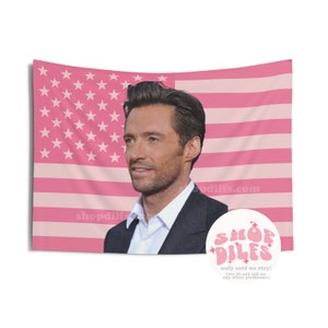 May include: Pink American flag tapestry featuring a portrait of a man in a suit. The flag design has pink stripes and stars. The text "shopdilfs.com" is visible on the flag. A circular logo with the text "SHOP DILFS" is in the lower right corner.
