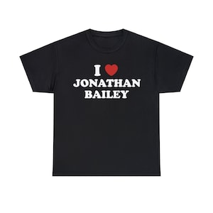 May include: Black t-shirt with the text "I ♥ Jonathan Bailey" in white block letters and a red heart. The shirt is a crew neck style and appears to be made of a soft material.
