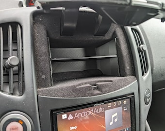 May include: A black car interior with a Pioneer car stereo displaying the Android Auto app. The screen shows the music note icon and the text "Android Auto".