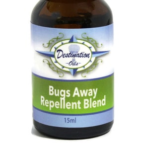 May include: A brown glass bottle with a black cap, labeled "Destination Oils - Bugs Away Repellent Blend" and "15ml".