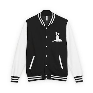 May include: Black and white varsity jacket with white sleeves. The jacket features a white graphic of a person on the front. The jacket has a button-up closure, white stripes on the cuffs and hem, and a white collar.
