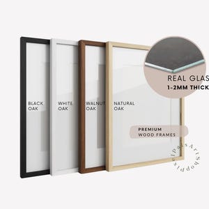 May include: Four rectangular wooden frames in black oak, white oak, walnut oak, and natural oak finishes. A circular inset shows a cross-section of the frame with real glass that is 1-2mm thick. The text reads Premium Wood Frames.