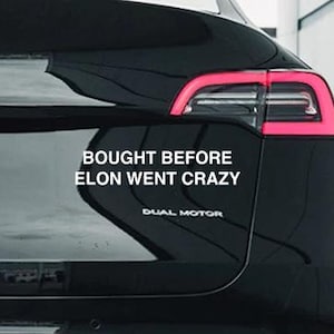 May include: Black Tesla Model Y with a white vinyl sticker that reads "Bought Before Elon Went Crazy".