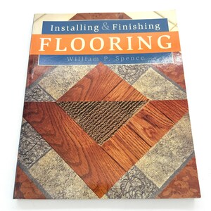 May include: A book titled "Installing & Finishing Flooring" by William P. Spence. The cover features a close-up of a wood floor with a patterned design.