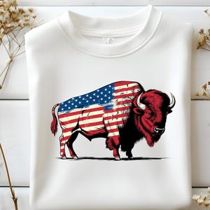 May include: White sweatshirt with a graphic of a red and blue American flag buffalo.