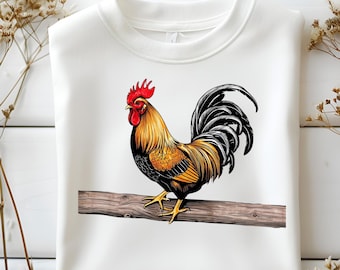 May include: A white sweatshirt with a graphic of a rooster standing on a branch. The rooster is brown, yellow, black, and red.
