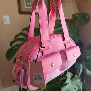 Juicy Couture pink and white lemonade pack it up bowler shoulder bag 2 front pockets accent and printed logo all over the purse image 3