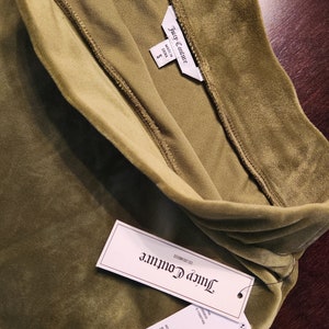 May include: A green velvet Juicy Couture top with a tag that says "Juicy Couture" and "Made in China". The tag also shows the size "S" and the price in USD and CAD.