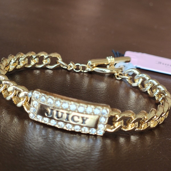 Juicy couture gold tone metal bracelet with rhinestones and rectangle logo accent