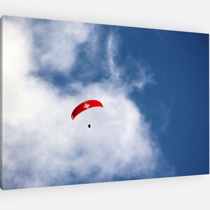 Lauterbrunnen Valley Switzerland Paraglider in blue skies of Swiss alps, picturesque scenery and blue skies Poster/Canvas Print