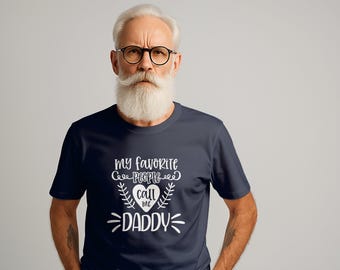 May include: A navy blue t-shirt with white text that reads "My favorite people call me Daddy" with a heart graphic.