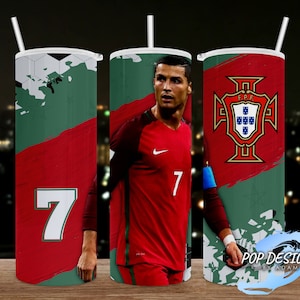 May include: Three stainless steel tumblers with straws. Each tumbler has a different design: a soccer ball graphic, a portrait of a soccer player in a red jersey, and the Portuguese coat of arms. The number 7 is displayed on one tumbler.