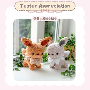 May include: Two crocheted plush toys, one brown and one light brown, with a white collar, sitting on a table with green leaves in the background. The caption reads "Tester Appreciation @By.Geekie".