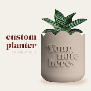 May include: A 3D printable custom planter with a scalloped rim. The planter is light brown and has the text "Your note here" printed on the side. A small green succulent plant is in the planter.